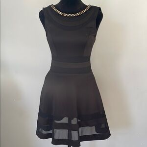 Elegant Black Sleeveless Dress with gold accents at neck